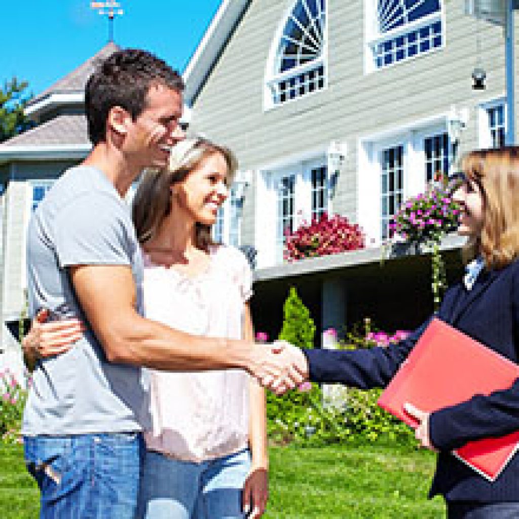 Happy family with agent realtor near new house.